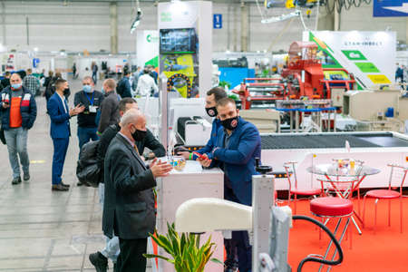 Kiev, Ukraine November 25 2020. Industrial Exhibition during a pandemic. People at the exhibition wearing medical masks. Exhibition and social distanceのeditorial素材