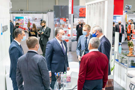 Kiev, Ukraine November 25 2020. Industrial Exhibition during a pandemic. People at the exhibition wearing medical masks. Exhibition and social distanceのeditorial素材