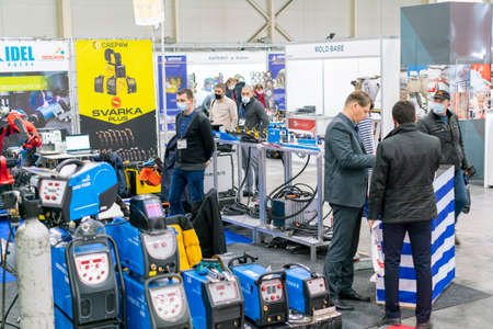 Kiev, Ukraine November 25 2020. Industrial Exhibition during a pandemic. People at the exhibition wearing medical masks. Exhibition and social distanceのeditorial素材