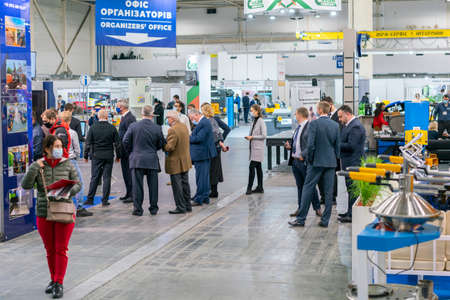 Kiev, Ukraine November 25 2020. Industrial Exhibition during a pandemic. People at the exhibition wearing medical masks. Exhibition and social distanceのeditorial素材