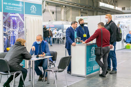 Kiev, Ukraine November 25 2020. Industrial Exhibition during a pandemic. People wearing medical masks during a pandemic. Exhibition and social distanceのeditorial素材