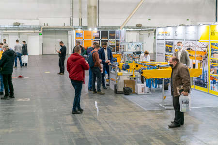 Kiev, Ukraine November 25 2020. Industrial Exhibition during a pandemic. People wearing medical masks during a pandemic. Exhibition and social distanceのeditorial素材