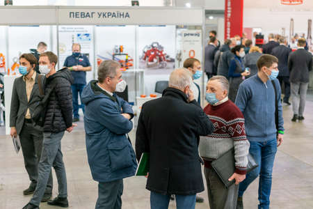 Kiev, Ukraine November 25 2020. Industrial Exhibition during a pandemic. People wearing medical masks during a pandemic. Exhibition and social distanceのeditorial素材