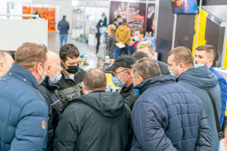 Kiev, Ukraine November 25 2020. Industrial Exhibition during a pandemic. People wearing medical masks during a pandemic. Exhibition and social distanceのeditorial素材