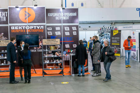 Kiev, Ukraine November 25 2020. Industrial Exhibition during a pandemic. People at the exhibition wearing medical masks. Exhibition and social distanceのeditorial素材