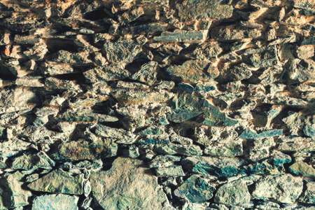 Ancient stone wall of the castle basement. Wall texture of ancient old brick stone. Outdoor exterior...