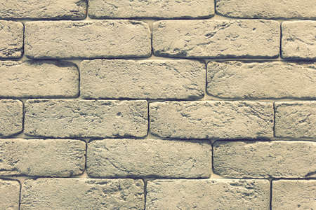 Stacked stone wall, natural stone cladding. Stone wall for background, Slab stone wall texture. Wall background of volcanic andesite basalt stone texture. toned.の写真素材
