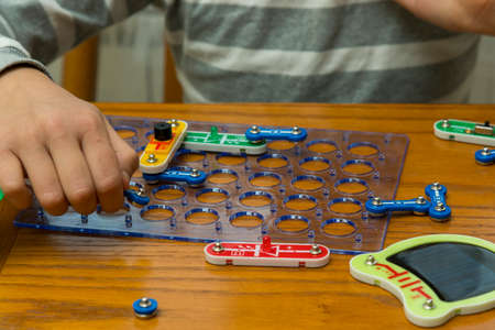 Cropped shot of a girl building a robot details close up education science technology robotics futuristic electronic mechanic developing creativity constructor playing toys concept. toned.の写真素材