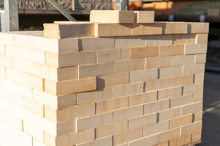 new brick block construction material on pallet. Beige bricks in the package, backgroundの写真素材