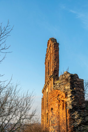 Ruined fortress against the blue sky. The ruins of an ancient fortress watchtower against the blue skyの写真素材