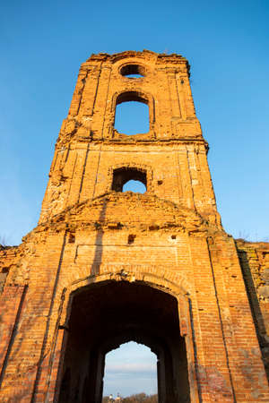Ruined fortress against the blue sky. The ruins of an ancient fortress watchtower against the blue sky. vertical photoの写真素材