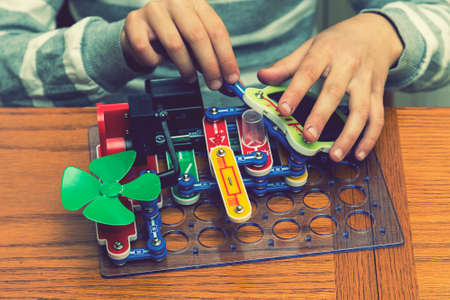 Cropped shot of a girl building a robot details close up education science technology robotics futuristic electronic mechanic developing creativity constructor playing toys concept. tonedの写真素材