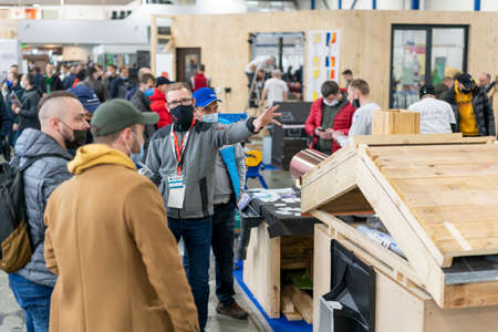 Kiev, Ukraine March 18 2021. international building exhibitionduring a pandemic. Equipment for construction and repair. Business meetings at the exhibition. Exhibition and social distanceのeditorial素材