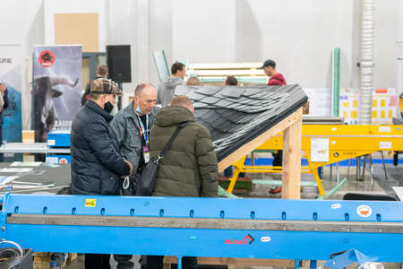 Kiev, Ukraine March 18 2021. international building exhibitionduring a pandemic. Equipment for construction and repair. Business meetings at the exhibition. Exhibition and social distance.のeditorial素材