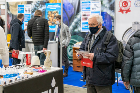 Kiev, Ukraine March 18 2021. international building exhibitionduring a pandemic. Equipment for construction and repair. Business meetings at the exhibition. Exhibition and social distance.のeditorial素材