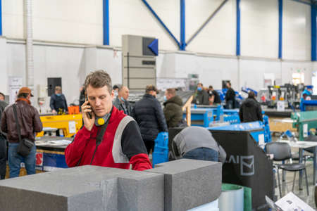 Kiev, Ukraine March 18 2021. international building exhibitionduring a pandemic. Equipment for construction and repair. Business meetings at the exhibition. Exhibition and social distance.のeditorial素材