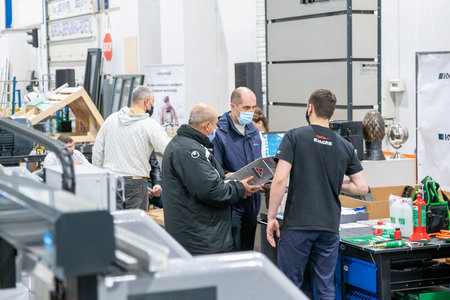 Kiev, Ukraine March 18 2021. international building exhibitionduring a pandemic. Equipment for construction and repair. Business meetings at the exhibition. Exhibition and social distance.のeditorial素材