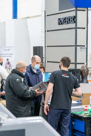 Kiev, Ukraine March 18 2021. international building exhibitionduring a pandemic. Equipment for construction and repair. Business meetings at the exhibition. Exhibition and social distance.のeditorial素材