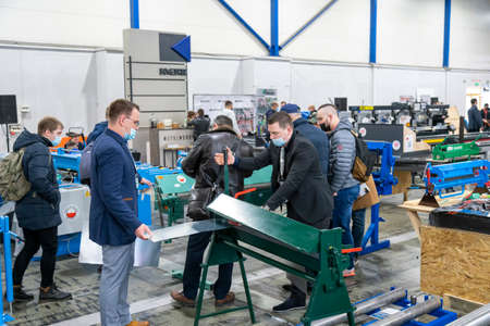 Kiev, Ukraine March 18 2021. international building exhibitionduring a pandemic. Equipment for construction and repair. Business meetings at the exhibition. Exhibition and social distance.のeditorial素材