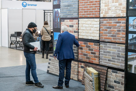 Kiev, Ukraine March 18 2021. international building exhibitionduring a pandemic. Equipment for construction and repair. Business meetings at the exhibition. Exhibition and social distance.のeditorial素材