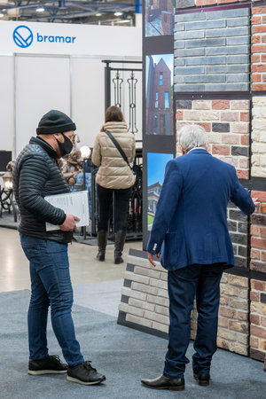 Kiev, Ukraine March 18 2021. international building exhibitionduring a pandemic. Equipment for construction and repair. Business meetings at the exhibition. Exhibition and social distance.のeditorial素材