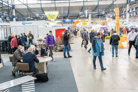Kiev, Ukraine March 18 2021. international building exhibitionduring a pandemic. Equipment for construction and repair. Business meetings at the exhibition. Exhibition and social distance.のeditorial素材