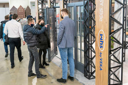 Kiev, Ukraine March 18 2021. international building exhibitionduring a pandemic. Equipment for construction and repair. Business meetings at the exhibition. Exhibition and social distance.のeditorial素材