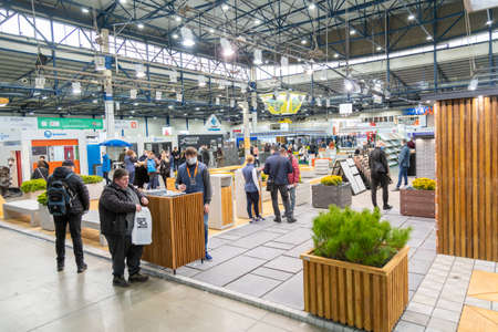 Kiev, Ukraine March 18 2021. international building exhibitionduring a pandemic. Equipment for construction and repair. Business meetings at the exhibition. Exhibition and social distance.のeditorial素材