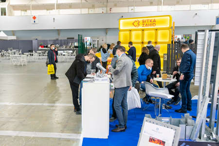 Kiev, Ukraine March 18 2021. international building exhibitionduring a pandemic. Equipment for construction and repair. Business meetings at the exhibition. Exhibition and social distance.のeditorial素材