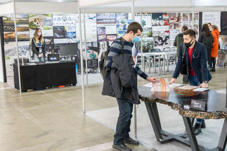 Kiev, Ukraine March 18 2021. international building exhibitionduring a pandemic. Equipment for construction and repair. Business meetings at the exhibition. Exhibition and social distance.のeditorial素材