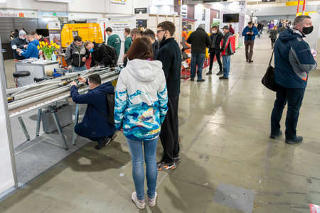 Kiev, Ukraine March 18 2021. international building exhibitionduring a pandemic. Equipment for construction and repair. Business meetings at the exhibition. Exhibition and social distance.のeditorial素材