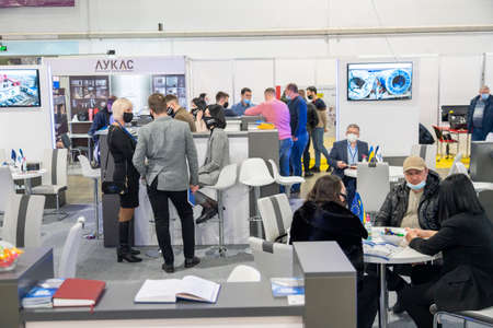 Kiev, Ukraine March 18 2021. international building exhibitionduring a pandemic. Equipment for construction and repair. Business meetings at the exhibition. Exhibition and social distance.のeditorial素材