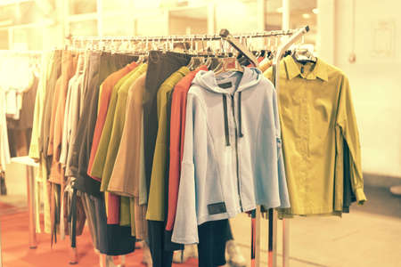 spring and summer womens clothing in the store. bright, modern clothes in a boutique. Womens hip clothing store interior concept. concept of choice of clothing. tonedの写真素材