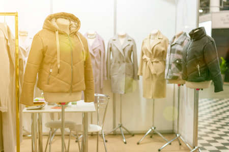 spring and summer womens clothing in the store. bright, modern clothes in a boutique. Womens hip clothing store interior concept. concept of choice of clothing. tonedの写真素材