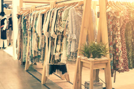 spring and summer womens clothing in the store. bright, modern clothes in a boutique. Womens hip clothing store interior concept. concept of choice of clothing. tonedの写真素材