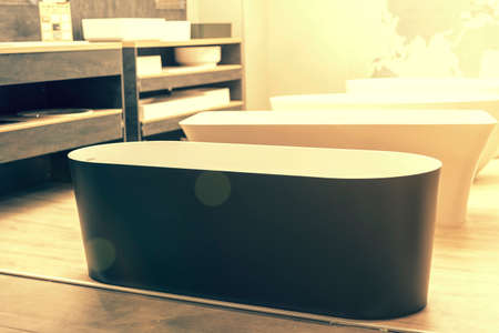 Black bathtub at a hardware store. Sanitary engineering shop. tonedの写真素材