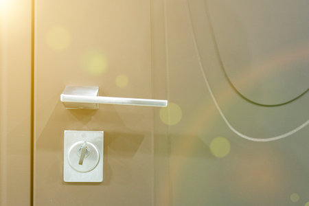 Keys stuck in a lock. closeup Door lock keys, Real estate concept door handle, Key insert and hold in metallic knob on white door horizontal. tonedの写真素材
