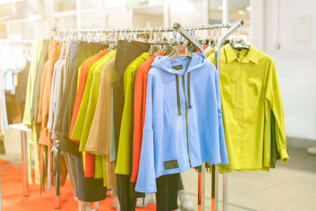 spring and summer womens clothing in the store. bright, modern clothes in a boutique. Womens hip clothing store interior concept. concept of choice of clothing. tonedの写真素材