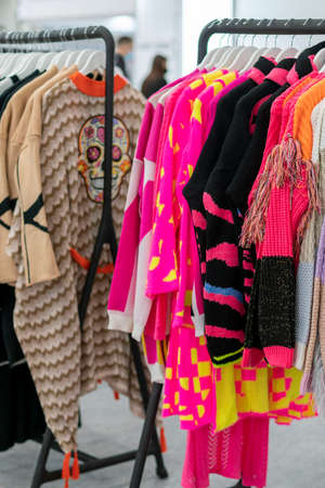 spring and summer womens clothing in the store. bright, modern clothes in a boutique. Womens hip clothing store interior concept. concept of choice of clothing. tonedの写真素材