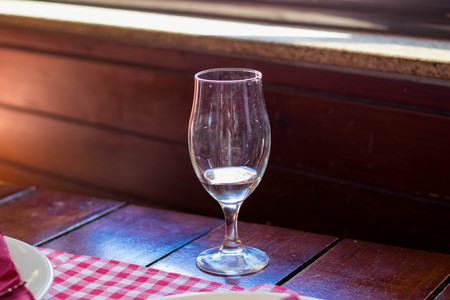 Dinner table set up in a restaurant with glass of waterの写真素材