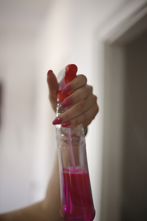 Woman hand hold a spray of cleaning fluidの写真素材