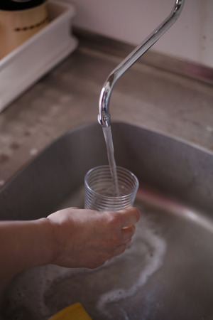 Pouring Fresh Tap Water Into a Glassの写真素材