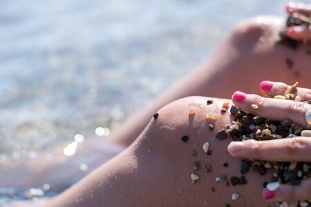 Woman legs on the sunset beachの写真素材