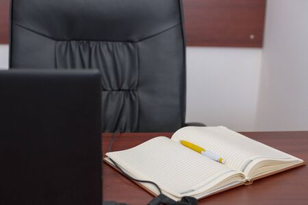 Wood office desk table with laptop, cup of coffeeの写真素材