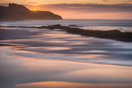 Sunset on the beach at Polzeath, Cornwall, UKの写真素材