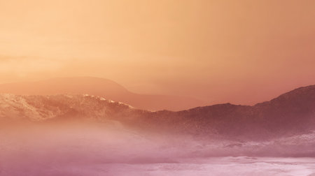 Misty mountain range soft orange and purple hues creating a serene and atmospheric landscape scene.の写真素材