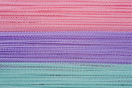Colorful paper strips as background, closeup view. Textile industry