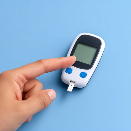Glucose meter in hand isolated on blue background. Health care and medical concept.
