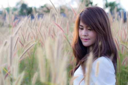 portrait of a girl in grass fieldの写真素材