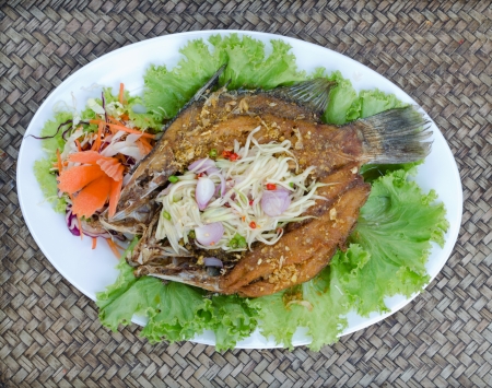 Tilapia fish fried  with mango saladの写真素材